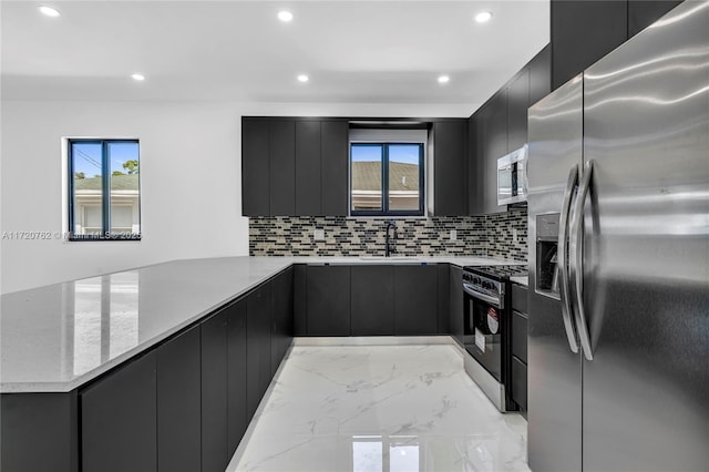 kitchen with backsplash, sink, light stone countertops, and stainless steel appliances