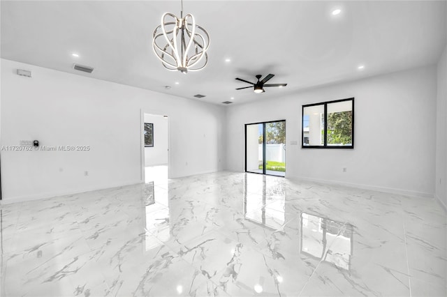 empty room featuring ceiling fan with notable chandelier