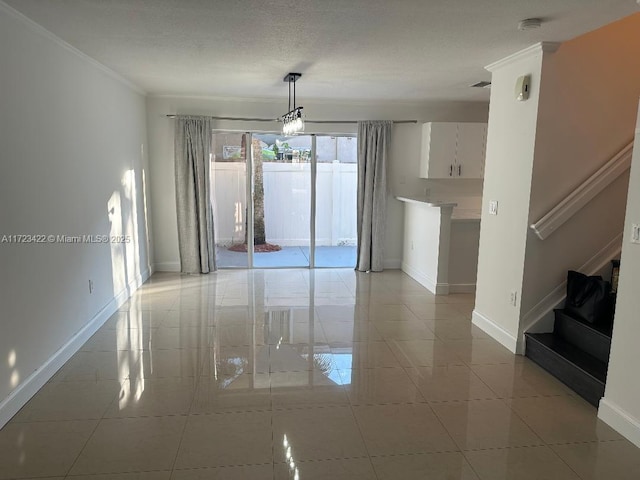 unfurnished room featuring crown molding, light tile patterned floors, a textured ceiling, and a notable chandelier