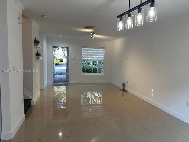 empty room featuring light tile patterned floors and ornamental molding