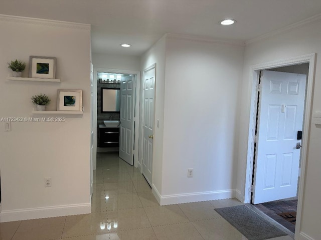 hall featuring light tile patterned floors and ornamental molding