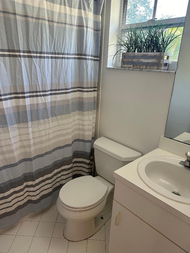 bathroom with tile patterned flooring, vanity, and toilet