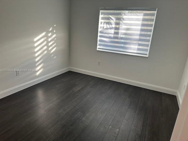 unfurnished room with dark hardwood / wood-style floors