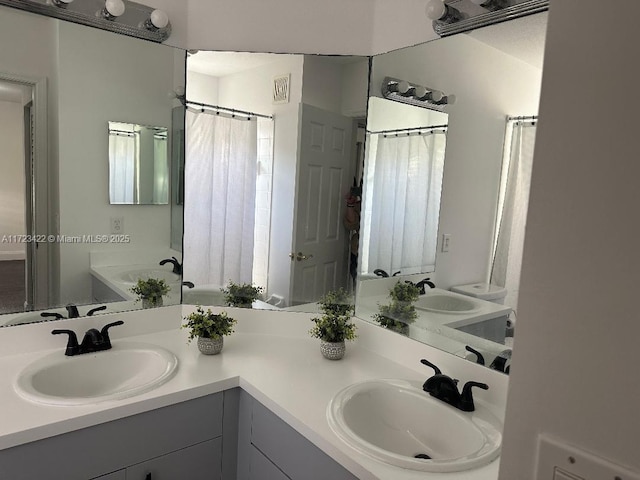 bathroom featuring vanity and a bath