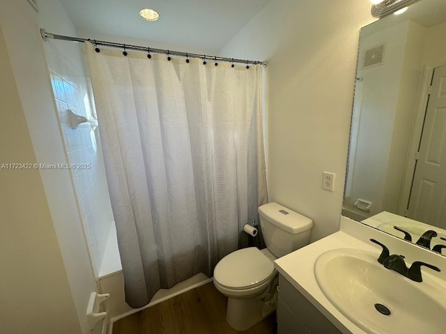 bathroom featuring walk in shower, hardwood / wood-style floors, vanity, and toilet