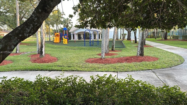 view of community featuring a playground and a yard