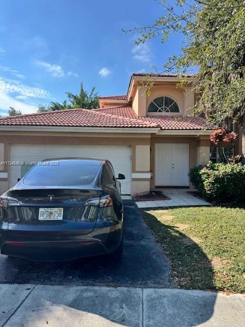 mediterranean / spanish-style home featuring a garage