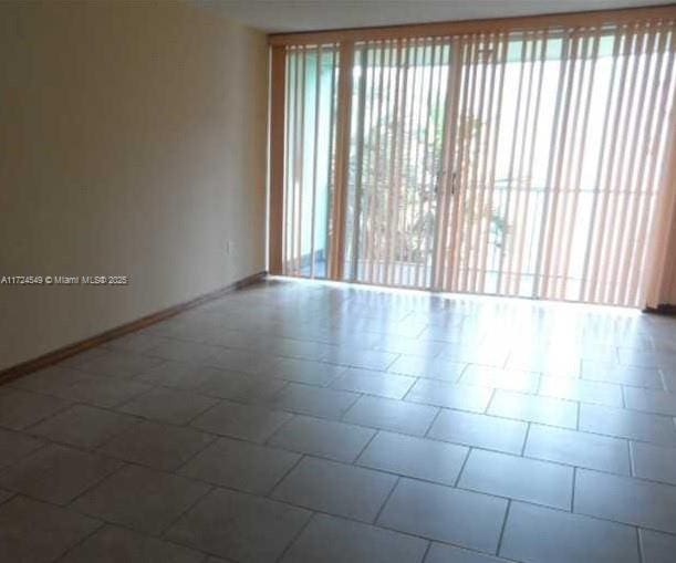 unfurnished room featuring tile patterned flooring