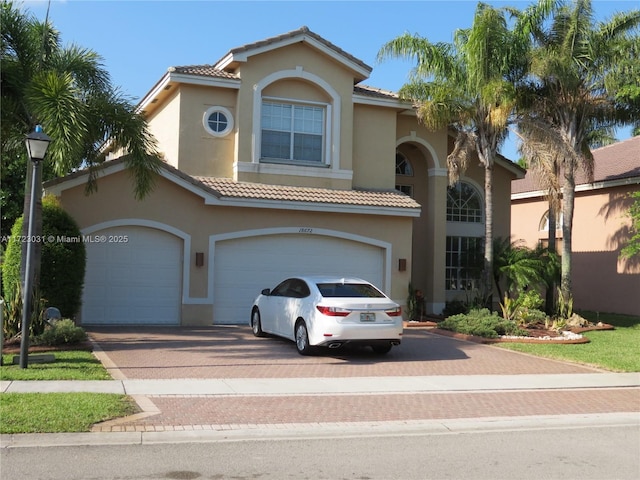 mediterranean / spanish home featuring a garage