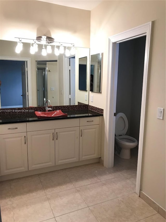 bathroom featuring tile patterned floors, vanity, and toilet