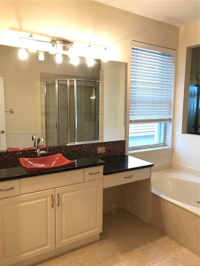 bathroom with tile patterned floors, plus walk in shower, and vanity