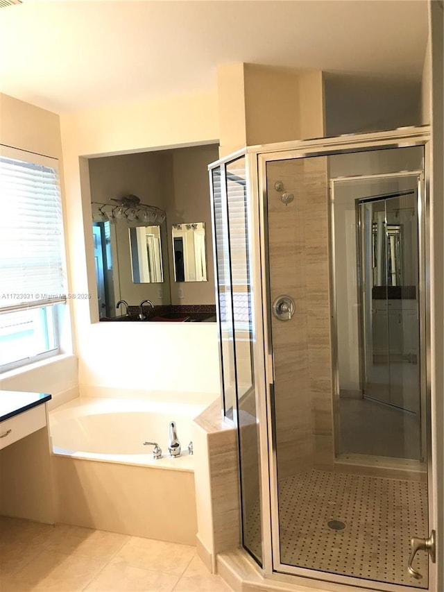 bathroom with tile patterned flooring, vanity, and independent shower and bath