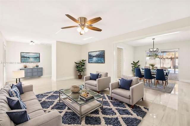 living room with ceiling fan with notable chandelier