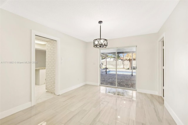 unfurnished dining area featuring a textured ceiling