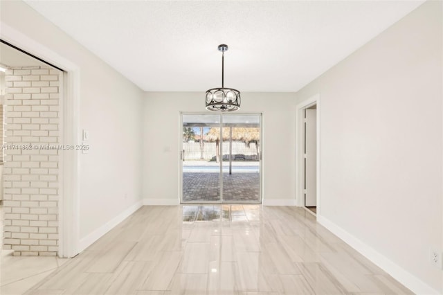 unfurnished dining area with a notable chandelier