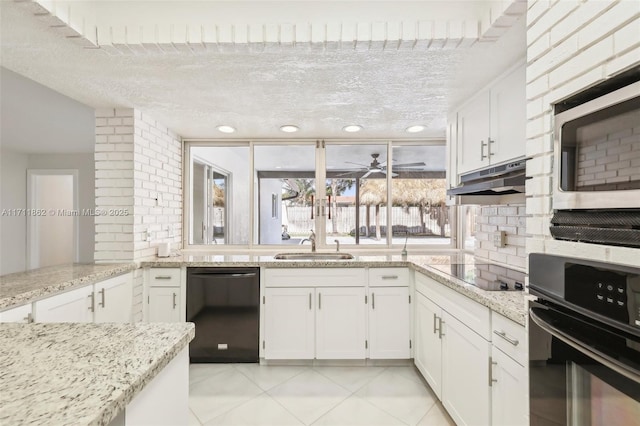 kitchen with sink, light stone counters, white cabinetry, and black appliances