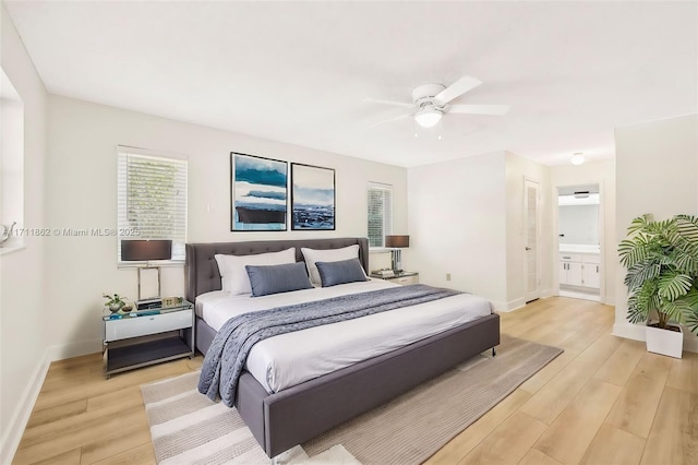 bedroom featuring connected bathroom, light hardwood / wood-style floors, and ceiling fan