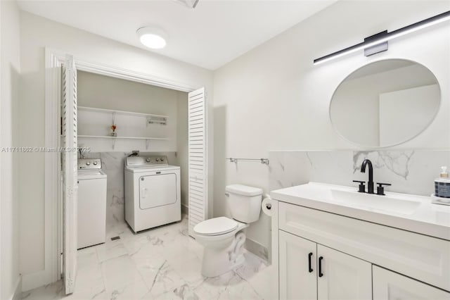 bathroom with vanity, toilet, tasteful backsplash, and washing machine and clothes dryer