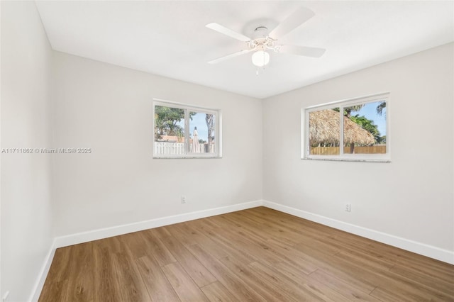 unfurnished room with hardwood / wood-style floors and ceiling fan