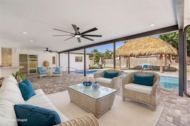 view of patio / terrace with outdoor lounge area, ceiling fan, a gazebo, and a fenced in pool