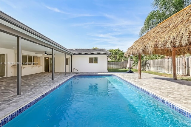 view of pool with ceiling fan and a patio