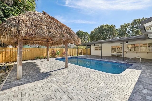 view of swimming pool featuring a patio area and ceiling fan