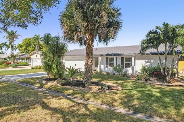 ranch-style home featuring a front yard and a garage