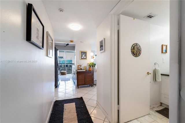 hall with light tile patterned floors