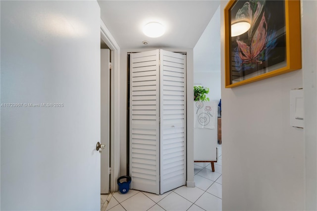 hall with light tile patterned floors