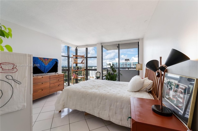 tiled bedroom with access to outside and floor to ceiling windows