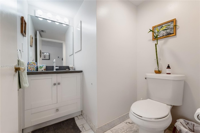 bathroom with tile patterned floors, vanity, and toilet