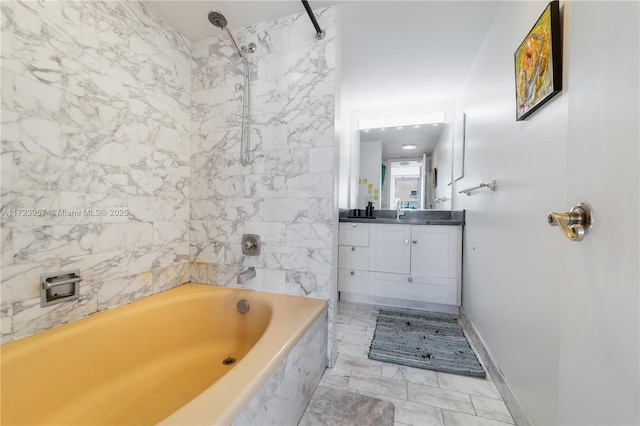 bathroom with vanity and tiled shower / bath combo