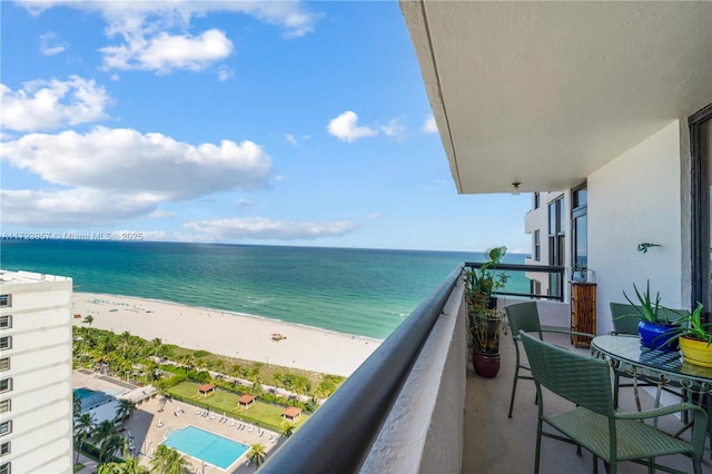 balcony with a view of the beach and a water view