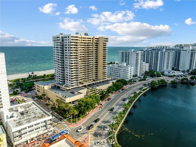 drone / aerial view featuring a water view and a view of the beach