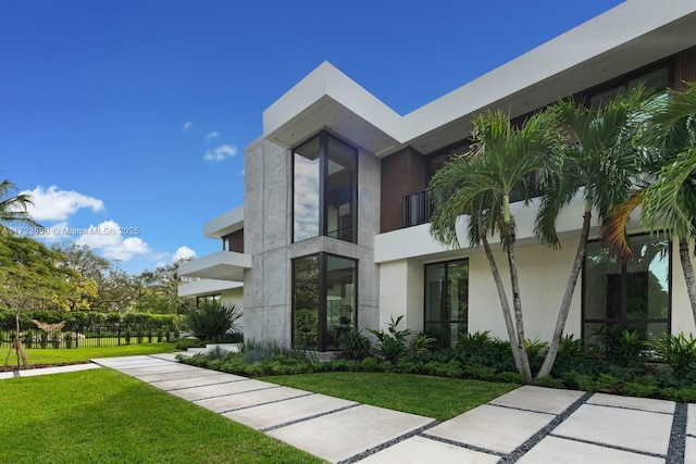 view of property exterior with a lawn and stucco siding