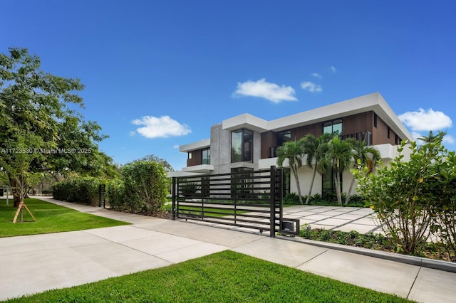 modern home with a front lawn and stucco siding