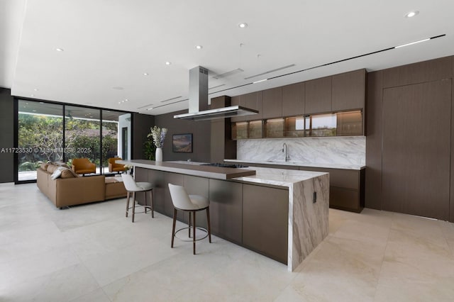 kitchen featuring backsplash, a sink, a large island, and modern cabinets