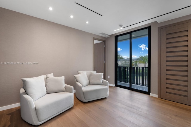 sitting room featuring recessed lighting, wood finished floors, visible vents, and baseboards