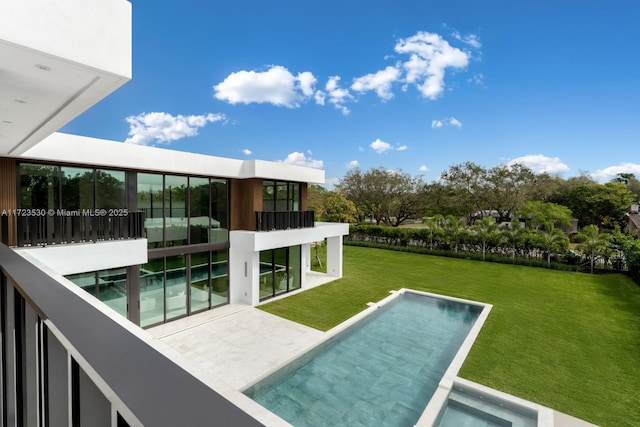 view of pool featuring a yard and a patio area