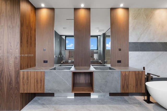 bathroom featuring recessed lighting, a freestanding bath, and vanity