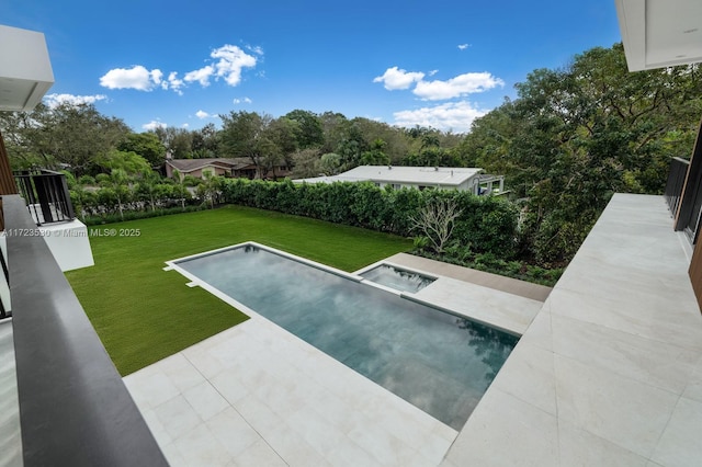 view of swimming pool featuring a yard and a patio area