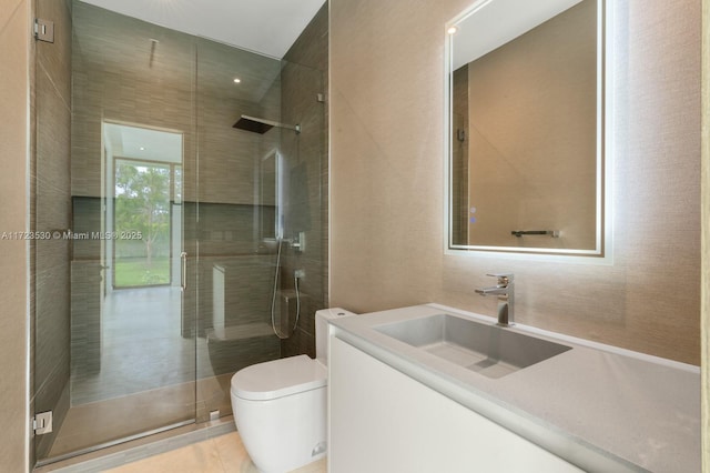 bathroom featuring toilet, a shower stall, and vanity