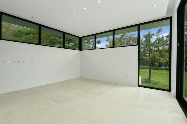 spare room featuring recessed lighting and plenty of natural light