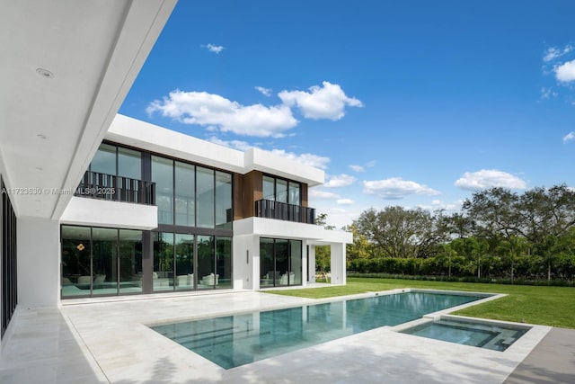 pool with a yard, a patio area, and an in ground hot tub