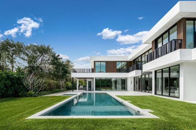 outdoor pool with a yard and a patio area