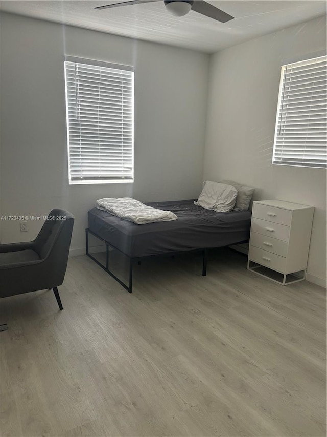 bedroom with light wood-type flooring and a ceiling fan