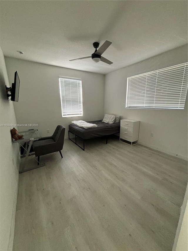 bedroom with ceiling fan and wood finished floors