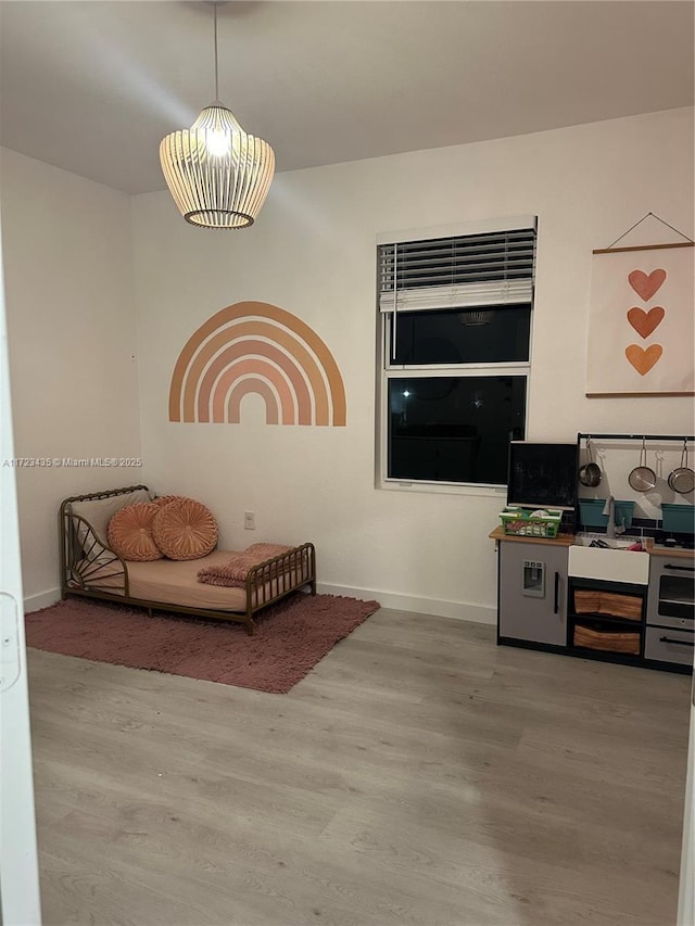 living area featuring wood finished floors and baseboards