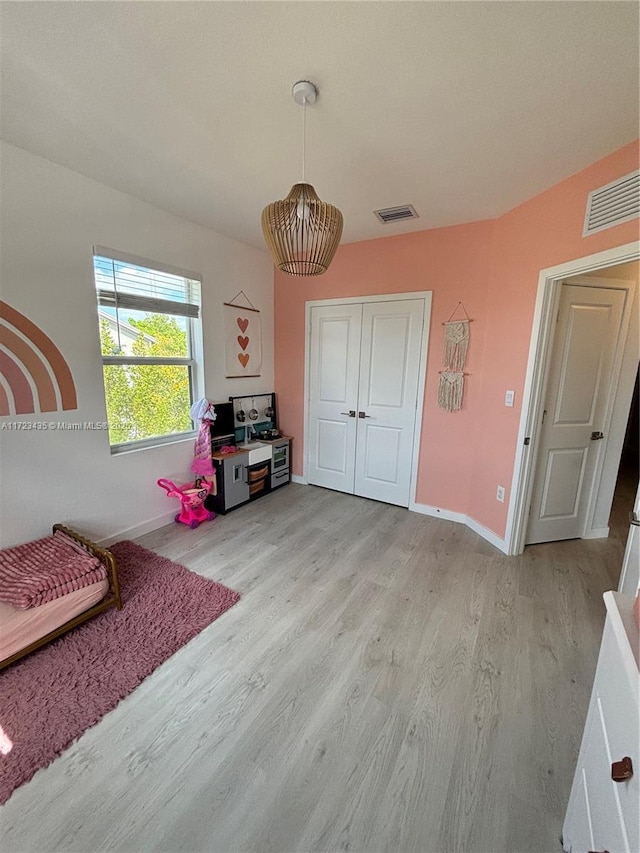 rec room featuring baseboards, visible vents, and light wood-style floors