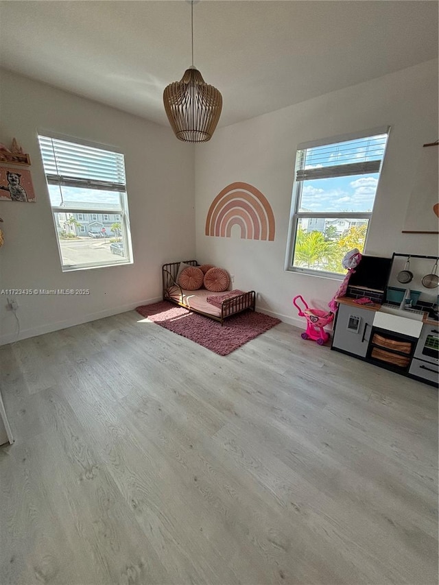 interior space with baseboards and wood finished floors